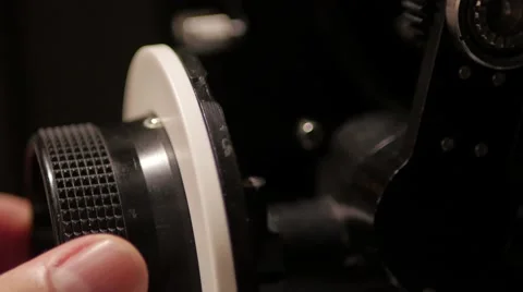 Hand pulls a professional follow focus on cinema camera with rig. 库存影片 68375135