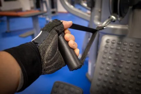A hand pulls a pulley at the gym Stock Photos