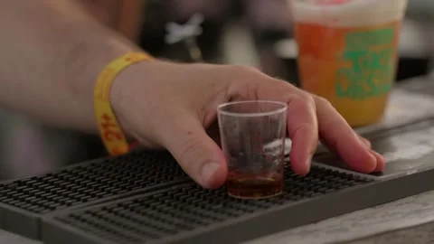 Hand pulls shot off bar slow motion Stock Footage 308125658