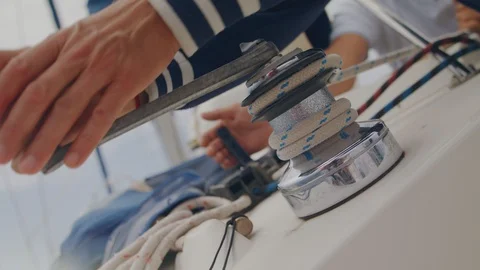 Hand pulls the winch close up. Rope of marine equipment on sailing vessel. Stock Footage 113365495