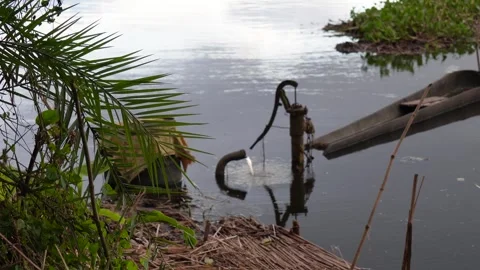 A hand pump and a small boat Stock Footage 320006483