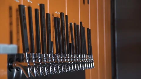 Hand pump beer taps selection at artisan microbrewery bar PULL FOCUS Stock Footage 301893247