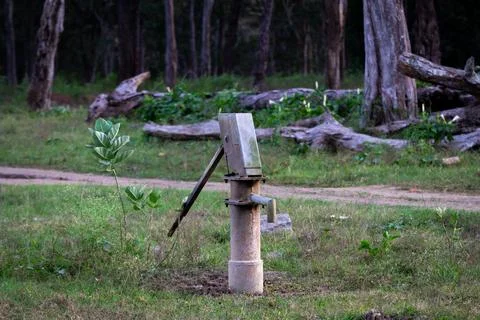A hand pump captured in middle of a forest Stock Photos