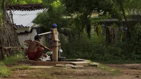 Hand Pump India - men is bathing near hand pump in India Stock Footage 162079188