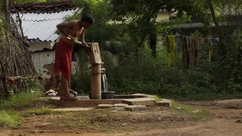 Hand Pump India - men using hand pump to collect water in India Stock Footage 162079253