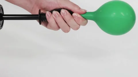 Hand Pumping a Green Balloon Step-by-Step Stock Footage 309515556