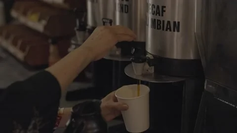 Hand pumps decaf coffee in cup cafe Stock Footage 218473638