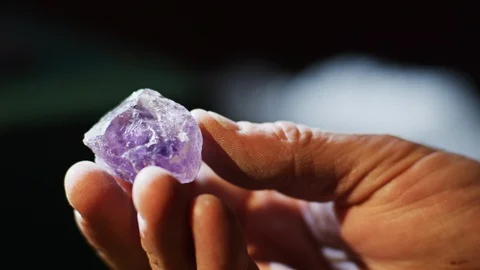 A hand with the purple crystal. Video stock 87906795