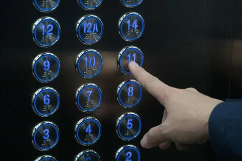 Hand push the elevator button 11th floor Stock Photos