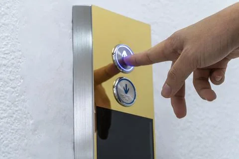 Hand push the elevator button up Stock Photos