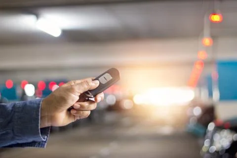 Hand push remote control of car on underground parking Fotos de archivo