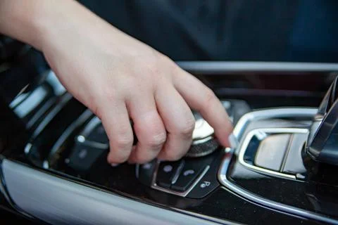 Hand push ring button on center console of modern car Stock Photos