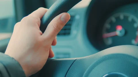 A hand pushes the cruise control button on a steering wheel. Stock Footage 89541330