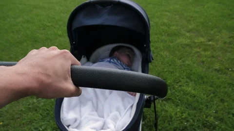 Hand pushes stroller Stock Footage 287845189