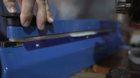 Hand pushing bag sealing machine Stock Footage 133125375