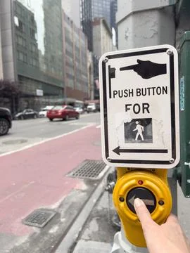 Hand pushing button for crosswalk Stock Photos