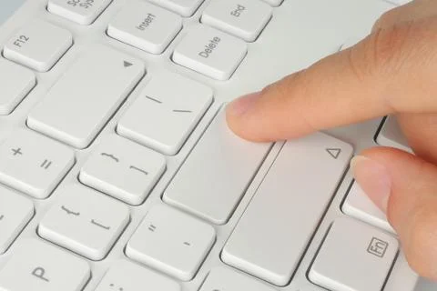 Hand pushing the button of keyboard Stock Photos