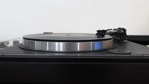 Hand pushing buttons on turntable with spinning vinyl record Stock Footage 120537876