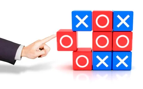 Hand pushing a circle to win the tic tac toe game Stock Photos