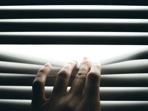 Hand is pushing closed blinds Stock Photos