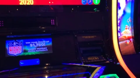 Hand pushing the continue spin button. A winning slot machine hitting a Stock Footage 115879383