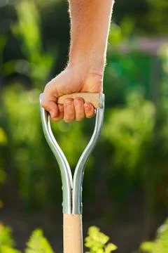 Hand pushing down spade Stock Photos