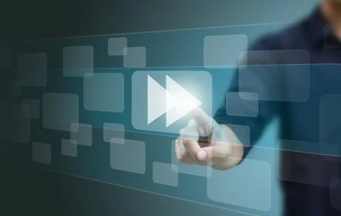 Hand pushing a fast forward button on a touch screen interface Stock Photos