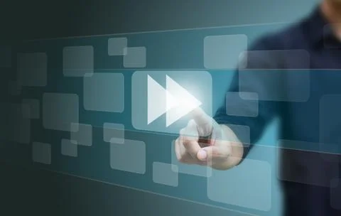 Hand pushing a fast forward button on a touch screen interface Stock Photos