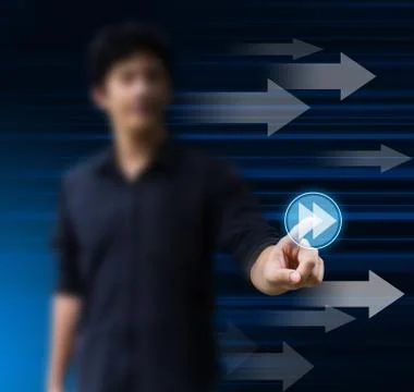 Hand pushing a fast forward button on a touch screen interface Stock Photos