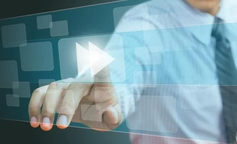 Hand pushing a fast forward button on a touch screen interface Stock Photos