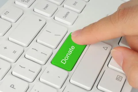 Hand pushing green donate button . Stock Photos
