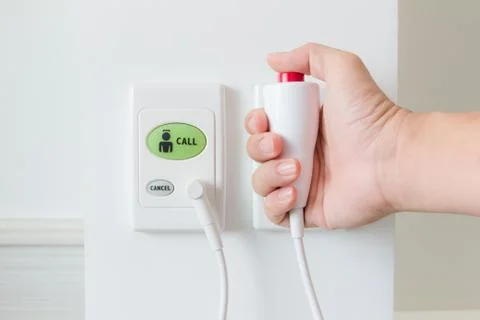 Hand pushing nurse call button Stock Photos