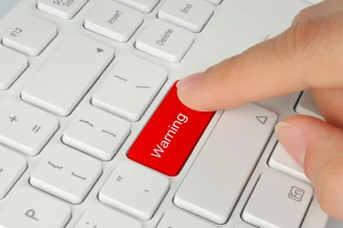 Hand pushing red warning button . Stock Photos