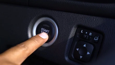 The hand is pushing start and stop engine of vehicle. Stock Footage 128349708