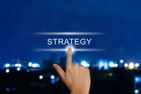 Hand pushing strategy button on touch screen Foto stock