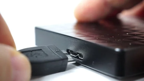 Hand pushing usb cable into usb slot on hard disk 4K Stock Footage 74364029