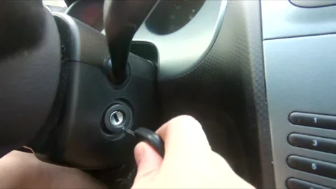 Hand put car key in keyhole to start the engine Stock Footage 195295669