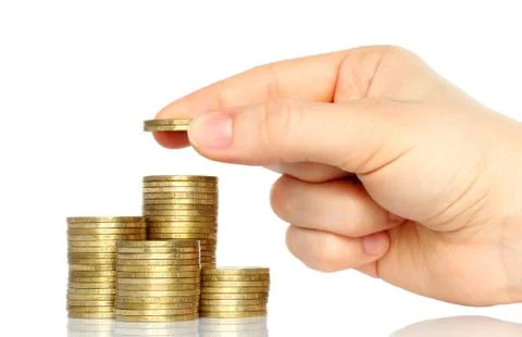 Hand put coins to stack of coins . Stock Photos