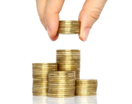 Hand put coins to stack of coins . Stock Photos