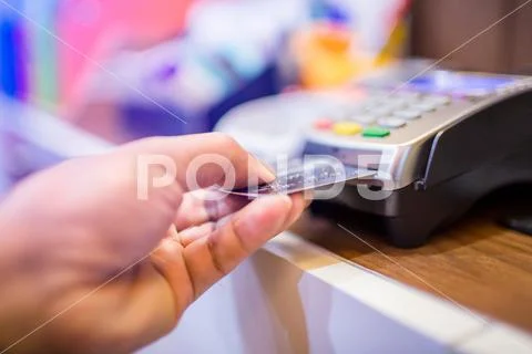 Hand put credit card In slot of credit card reader, credit card payment Stock Photos