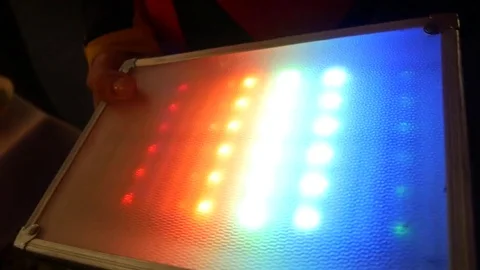 Hand put on device and different colorful bulbs  Stock Footage 83620189