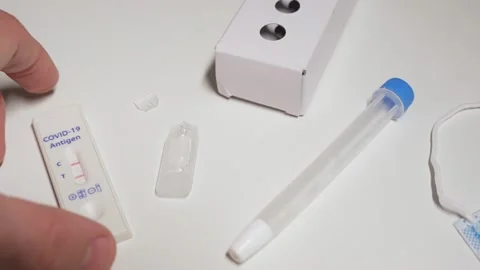 Hand put device with positive result for Covid-19 Antigen home testing kit Stock Footage 169408071