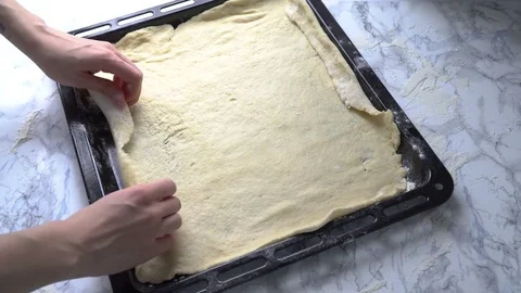 The Hand put dough in the form for pizza Stock Footage 84100009
