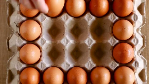 Hand put an eggs in to tray Stock Footage 129171875