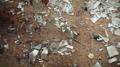 Hand put the glass down on the floor with broken glass Stock Footage 81702493