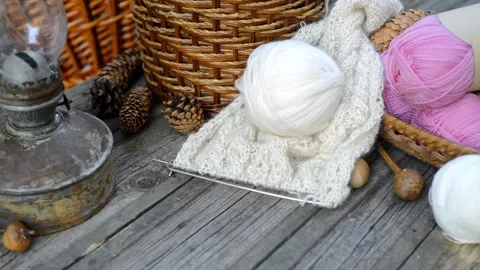 Hand put knitting work and white ball of wool on vintage wood desk Stock-Footage 118255287
