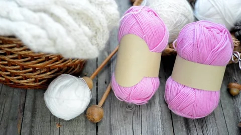 Hand put knitting work on basket and ball on desk. Stock Footage 118254683