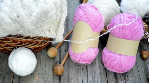 Hand put knitting work on basket and ball on wood desk. Video stock 118254724