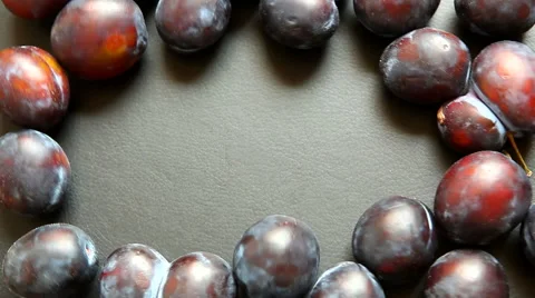 Hand put one plum to the copy space in the middle of black background with plums 動画素材 65419268