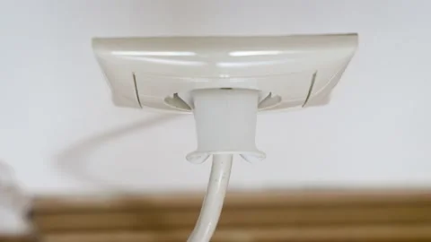 Hand put a plug into a white European electrical socket. Stock Footage 237524725